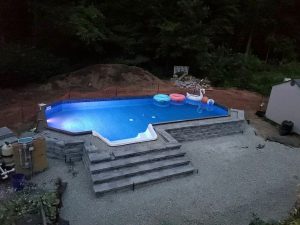 An attractive hybrid pool installed in a residential backyard.